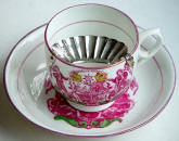 http://antiquescientifica.com/silver_moustache_guard_1887-88_on_teacup.jpg